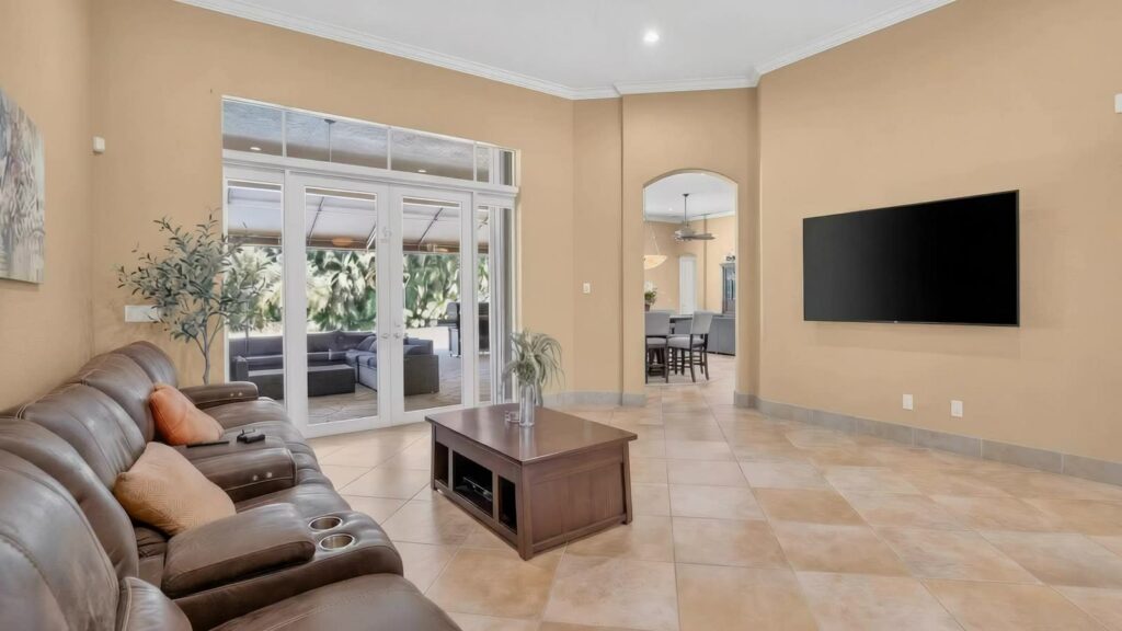 Living room with French doors opening to the covered patio