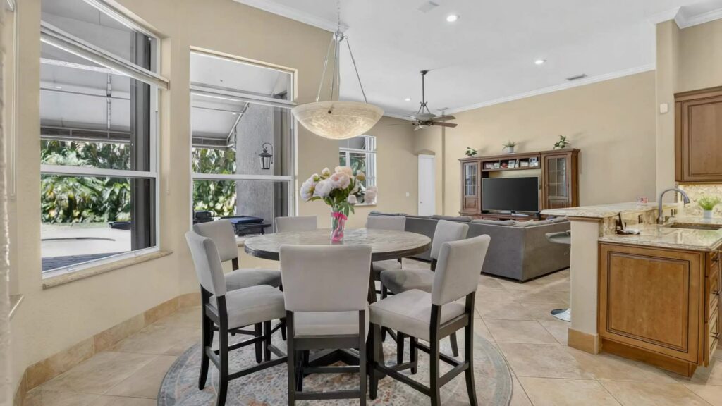 Breakfast area and family room open to the kitchen with pool views