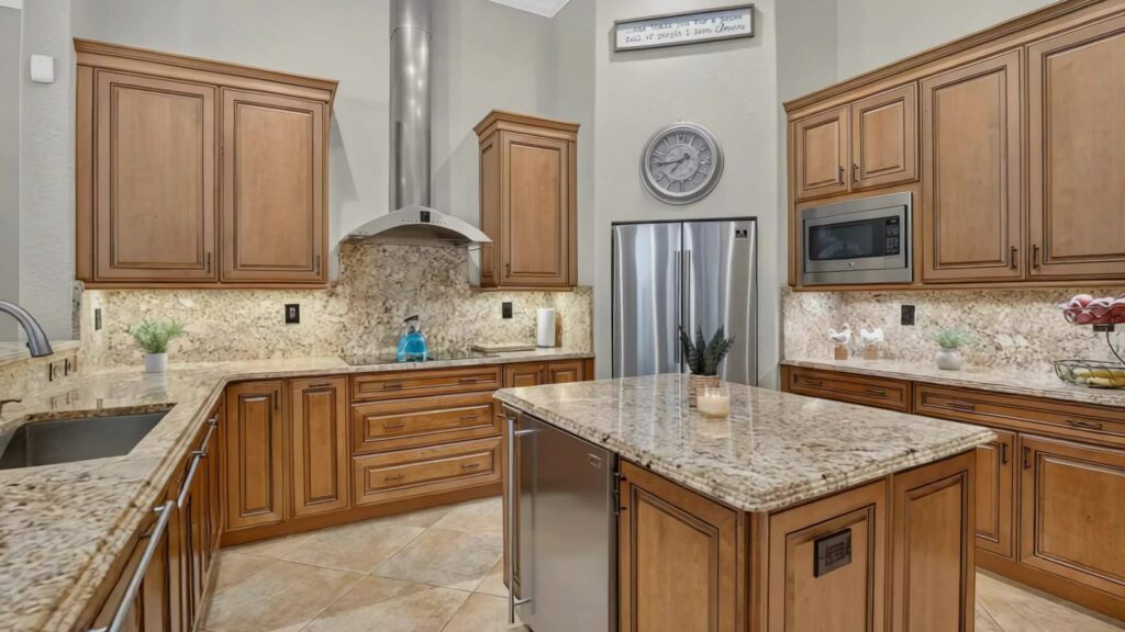 Gourmet kitchen with granite counters, centre island, vented hood and stainless appliances