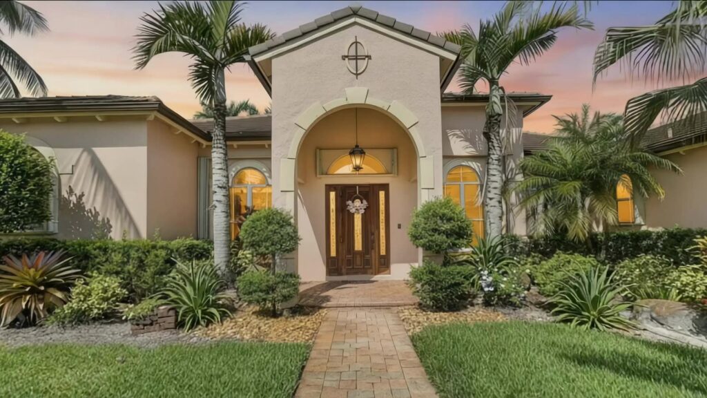 Covered front entry and barrel tile roofline at dusk, 3143 SW 141st Terrace, Davie