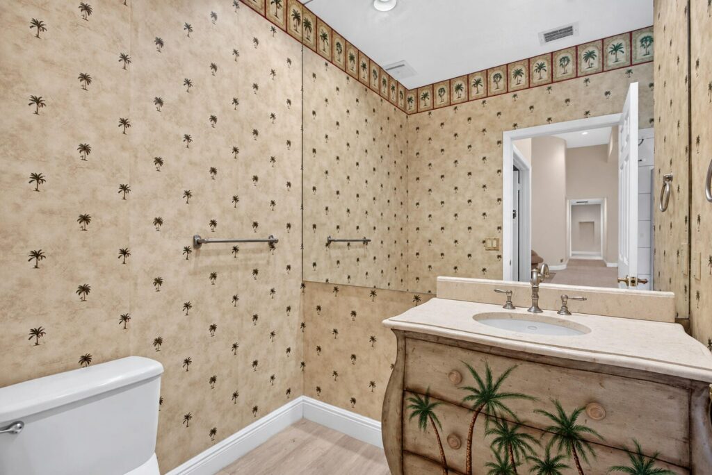 Full bathroom with a vanity and decorative wallpaper