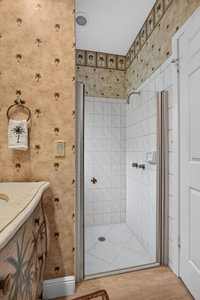 Walk in glass shower in a full bathroom