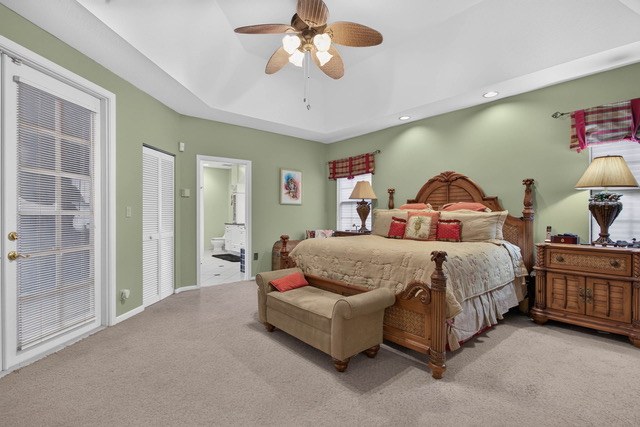 Bedroom with a ceiling fan and carpet