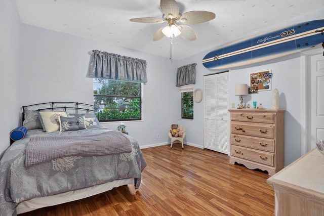 Bedroom with wood floors and a ceiling fan