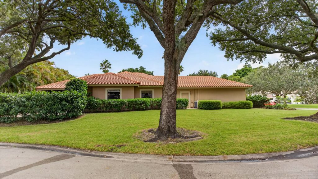 Corner homesite with a broad lawn under mature oak trees