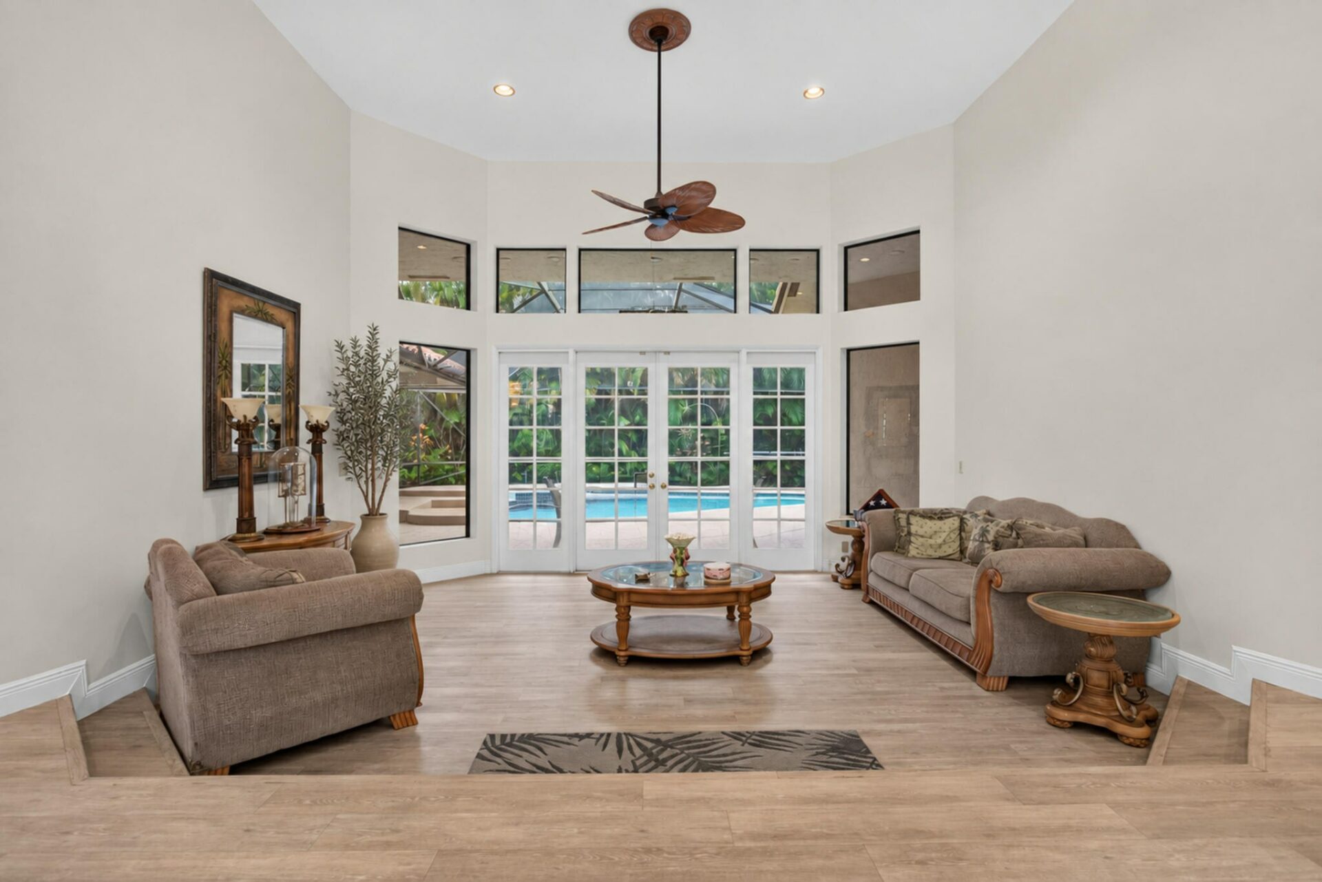 Formal living room with French doors to the pool