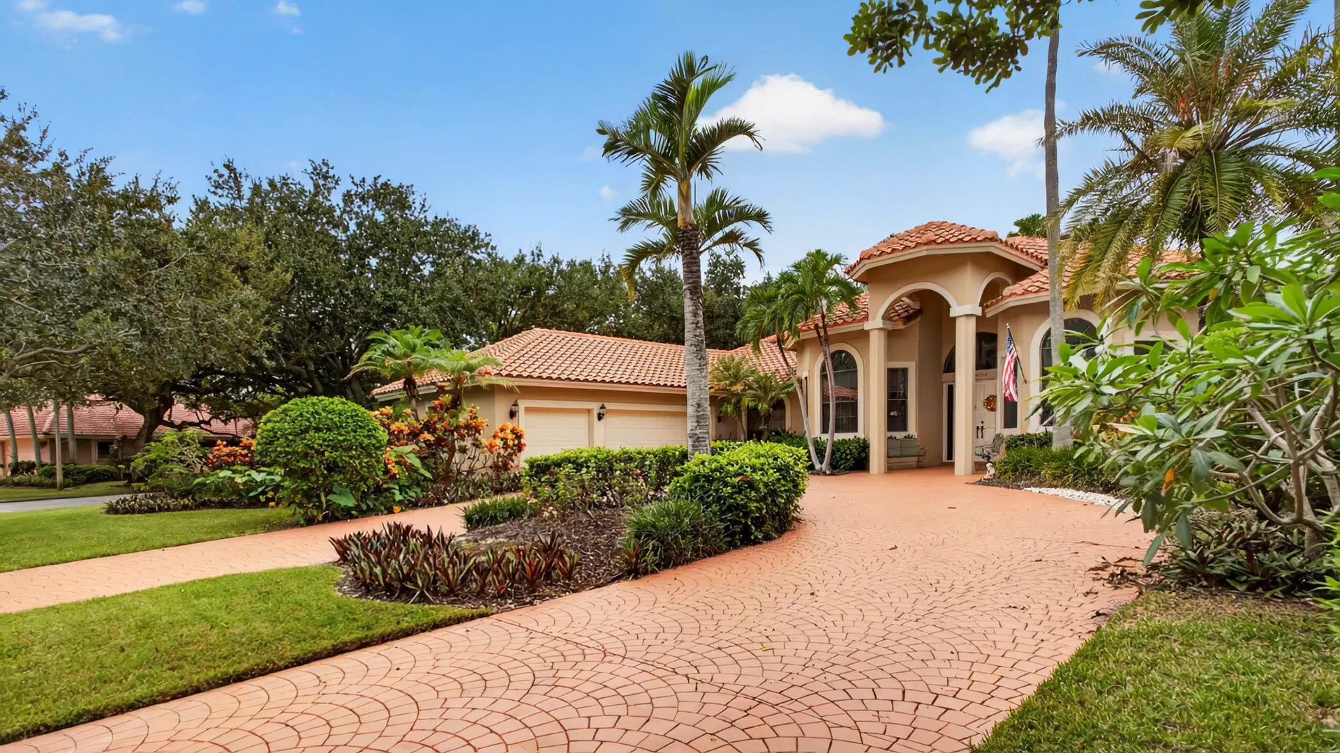 Arched front entry and barrel tile roof in daylight, 10240 Vestal Court