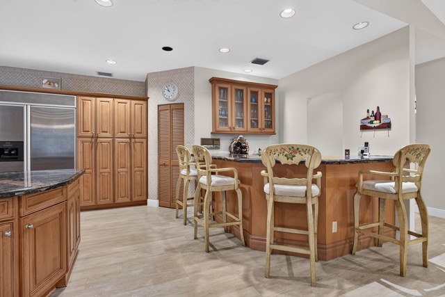 Kitchen bar seating with the refrigerator wall behind