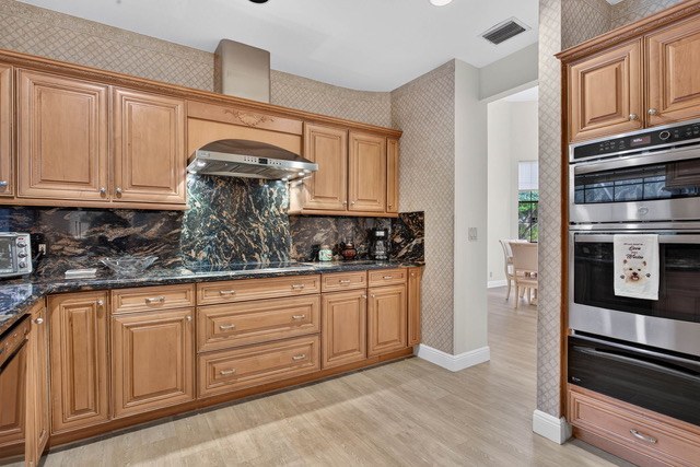 Kitchen wall ovens beside the cooktop run