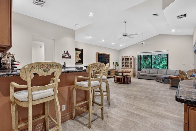 Kitchen bar opening to the family room