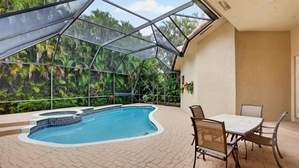 Heated pool and spa with patio dining under the screen enclosure